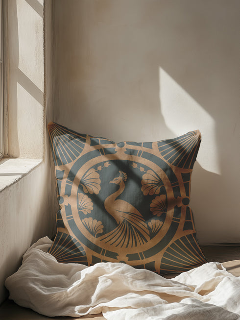 Square pillow cover featuring a stylized copper peacock design centered in a medallion, surrounded by Art Deco fan patterns and shell motifs on a dark forest green background.